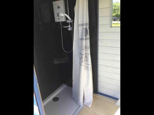 a shower with a white shower curtain in a bathroom at Horsemans Stargazing Tent in Kingsbridge