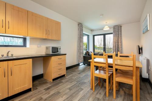 a kitchen and dining room with a table and chairs at Clarion Village in Sligo