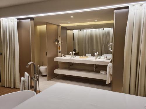 a bathroom with a sink and a large mirror at Zenite Boutique Hotel & SPA in Angra do Heroísmo