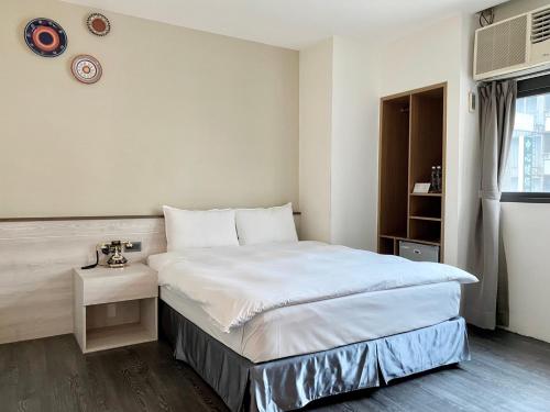 Postel nebo postele na pokoji v ubytování Raise Hotel Taichung