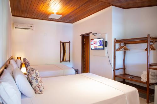 Ένα ή περισσότερα κρεβάτια σε δωμάτιο στο Tororao Hotel Pousada