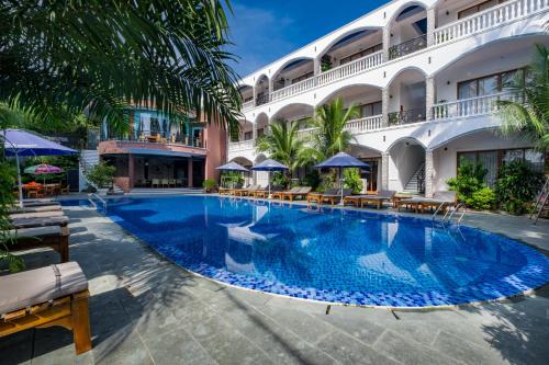 a large swimming pool in front of a hotel at Brenta Phu Quoc Hotel in Phu Quoc