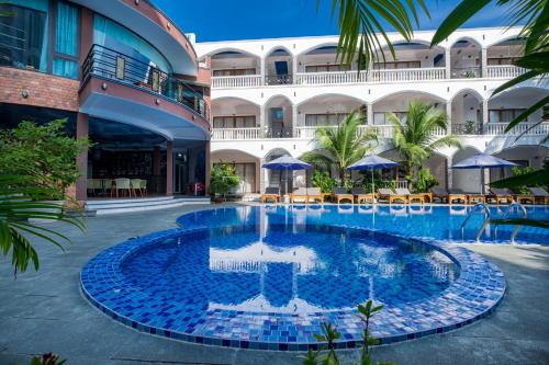 a swimming pool in the middle of a building at Brenta Phu Quoc Hotel in Phu Quoc