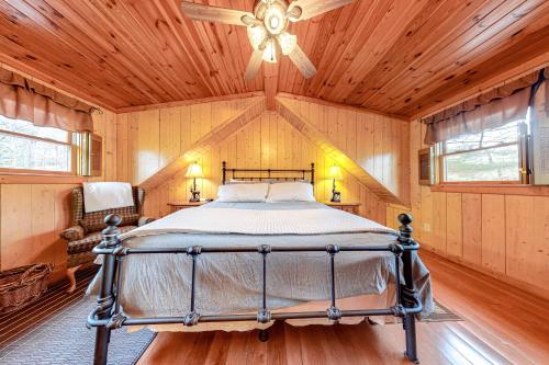 a bedroom with a bed in a room with wooden ceilings at Tranquility Place in Lakemont