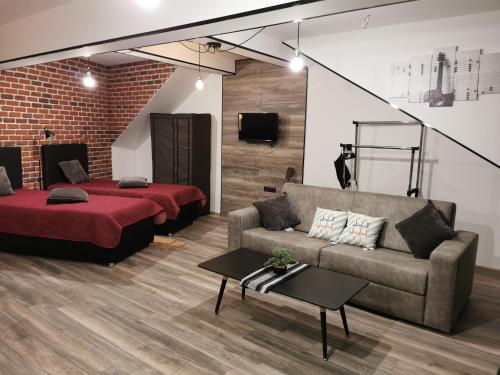 a living room with a couch and a bed at Urban Music Studio byPMM in Plovdiv