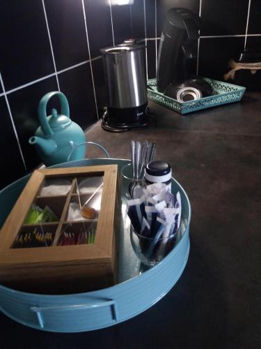 a table with a tray of utensils and a container of utensils at Gastenverblijf 't Achterhoes in Bellingwolde