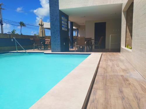 a house with a swimming pool and a patio at Tropical Praia Hotel in Aracaju
