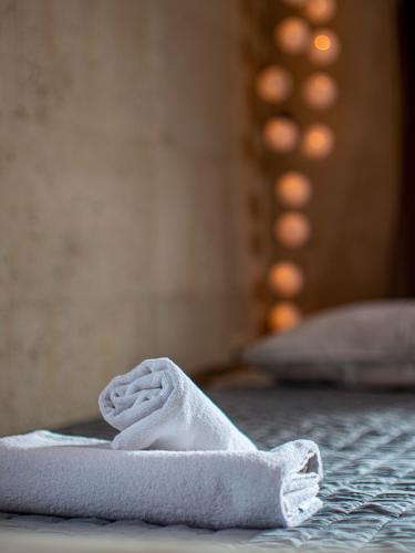 a towel sitting on top of a bed at Pezoulia in Selakano