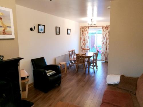 a living room with a dining room table and chairs at 4 bedrooms house at Enniscrone 400 m away from the beach with enclosed garden and wifi in Enniscrone