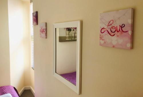 a mirror hanging on a wall in a room at Pavilion Holiday Apartments in Weston-super-Mare
