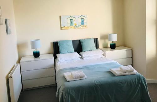 a bedroom with a bed with two pillows on it at Pavilion Holiday Apartments in Weston-super-Mare