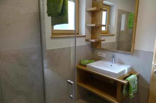 uma casa de banho com um lavatório e um chuveiro em Schmalzlhof em Siusi