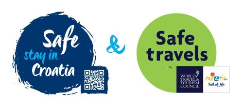 two stickers with the words safe travels and stay in croatia at Zen Luxury Apartments in Zadar