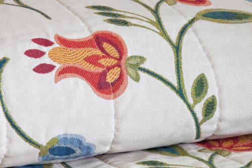 a pillow with a flower pattern on it at Hotel Katja in Bibione