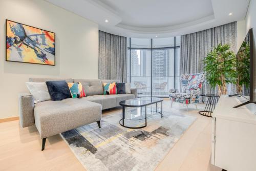 a living room with a couch and a table at RH- Downtown Oasis, Spacious 01 BR in Downtown near Dubai Mall in Dubai
