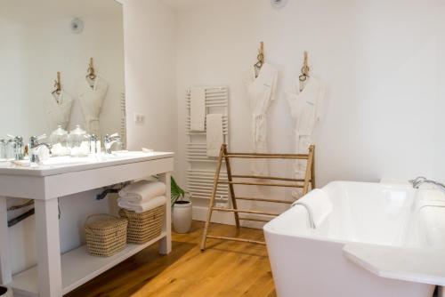 a bathroom with a sink and a tub and a bath tub at La Palmeraie in La Baule