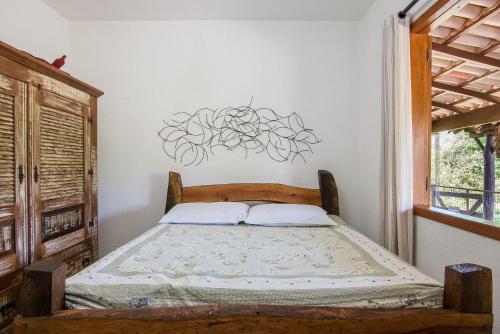 a bedroom with a bed in a room with a window at Sítio Pandora - Interior de Minas por Carpediem in Pedro Leopoldo