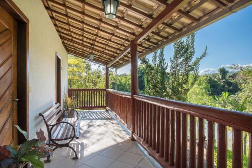 a porch with a chair and awning on a house at Sítio Pandora - Interior de Minas por Carpediem in Pedro Leopoldo