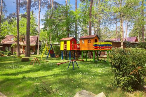 a park with a playground in the grass at Kotwica Morska in Pobierowo