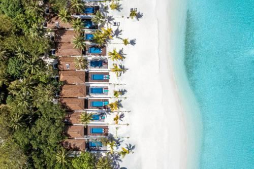 an aerial view of a beach with a resort at Villa Nautica Paradise Island Resort in North Male Atoll