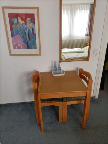 a wooden table in a room with a mirror at Hotel-Restaurant Babylon in Dierdorf
