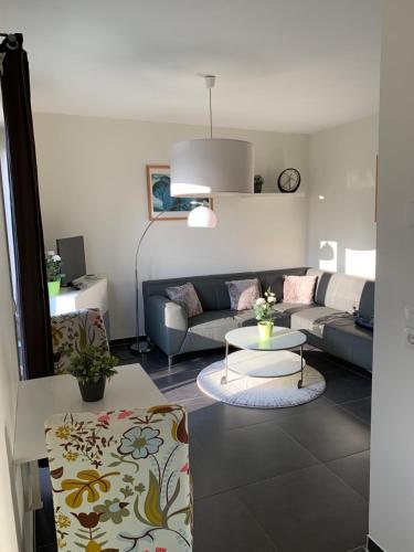 a living room with a couch and a table at Ferienwohnungen Göhren Urlaub mit Hund in Göhren