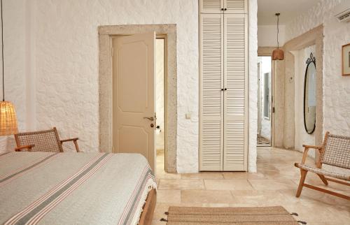 a bedroom with a bed and a white door at Morro Alacati in Alacati