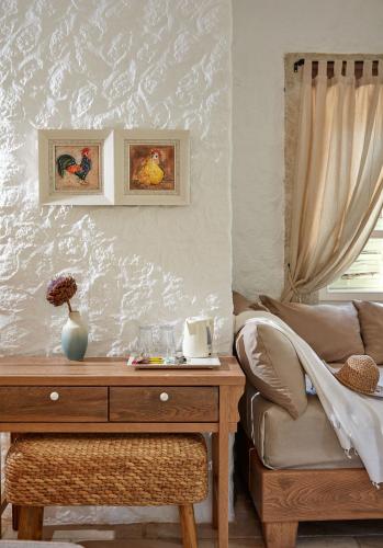 a table with a vase on it next to a couch at Morro Alacati in Alacati