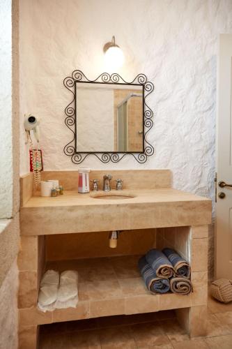 a bathroom with a sink and a mirror at Morro Alacati in Alacati