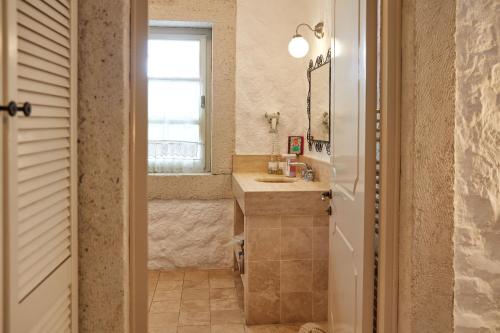 a bathroom with a sink and a mirror at Morro Alacati in Alacati