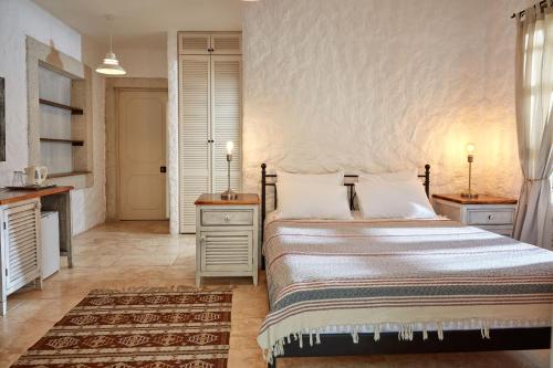 a bedroom with a bed and two night stands at Morro Alacati in Alacati