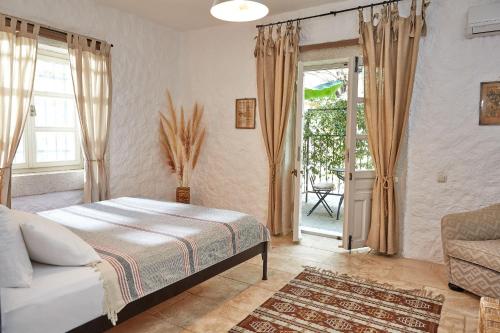 a bedroom with a bed and a sliding glass door at Morro Alacati in Alacati