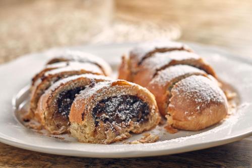 three pastries on a white plate on a table at Morro Alacati in Alacati