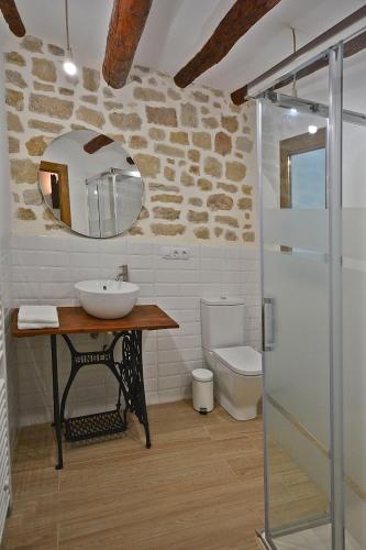 a bathroom with a sink and a toilet at Casa del Tio Vicente in Calaceite