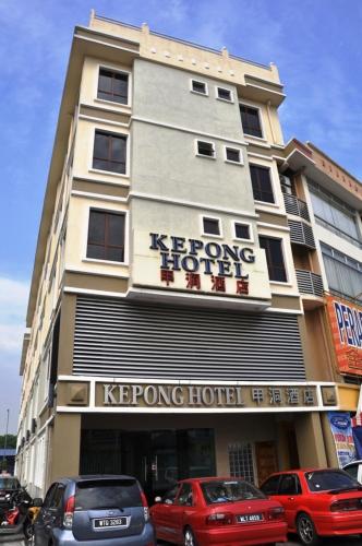 a hotel with cars parked in front of it at Kepong Hotel in Kuala Lumpur