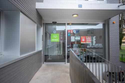 an entrance to a building with a revolving door at Nyon Hostel in Nyon