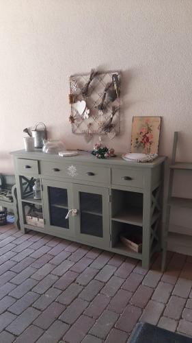 a white cabinet against a wall in a room at Guest House Romantika Panzio in Gyula