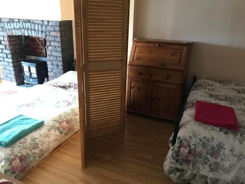 a bedroom with a bed and a dresser next to a bed at Ground Floor - view of Lighthouse, Garden and Parking in Swansea