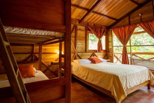 a bedroom with two bunk beds in a cabin at Mindo Lago Hotel Destino in Mindo