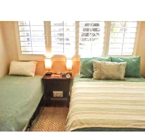 a room with two beds and a window at Cool Casual Living A/C,Non-Smoking, 25+ and over in Lakewood