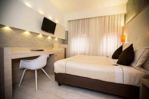 Ένα ή περισσότερα κρεβάτια σε δωμάτιο στο Agape Hotel AA Hotels