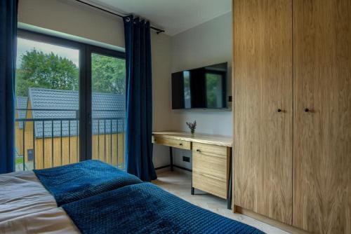 Postel nebo postele na pokoji v ubytování Ośrodek Wypoczynkowy Zapach Drewna Resort & Lake