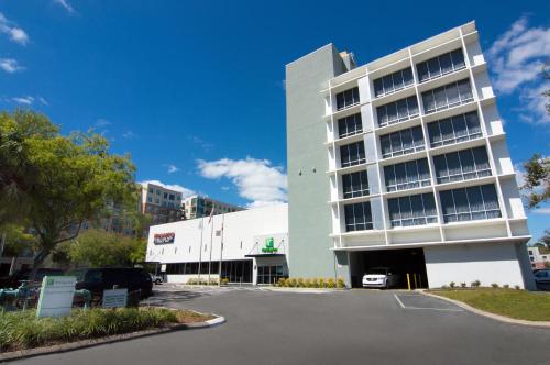 a building with a car parked in front of it at Holiday Inn Gainesville-University Center by IHG in Gainesville