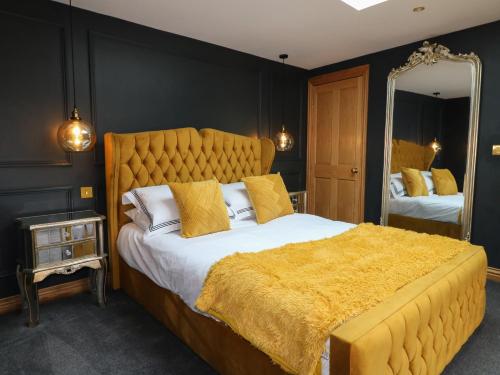 a bedroom with a large bed and a large mirror at The Forge in Lincoln