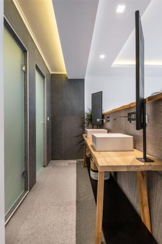 a bathroom with a sink on a wooden counter at NISSEA Boutique Hotel in Kardamaina
