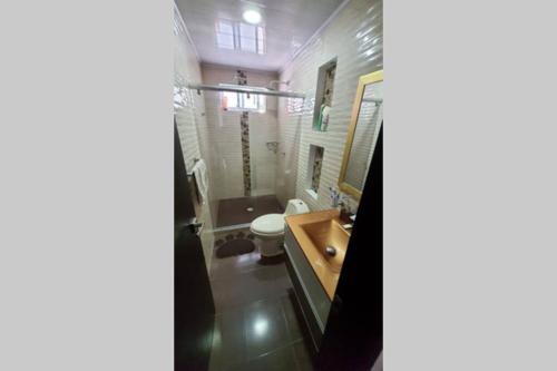 łazienka z toaletą i umywalką w obiekcie Casa quinta Las Palmas w mieście Villavicencio