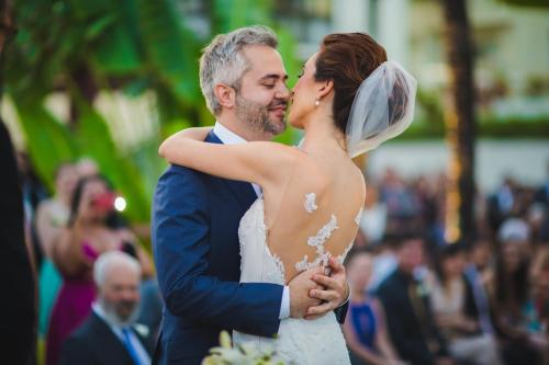 a bride and groom kissing during their wedding ceremony at CASA Di VINA Boutique Hotel in Salvador