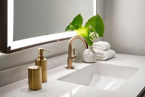 a bathroom sink with a faucet and a mirror at PGA National Resort in Palm Beach Gardens