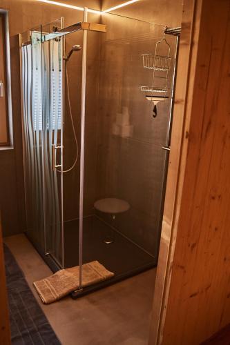 a shower in a bathroom with a glass shower stall at Chalet Ablon in Saalbach Hinterglemm