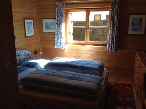 a room with three beds in a log cabin at Ferienhaus Zirmheim in Pertisau